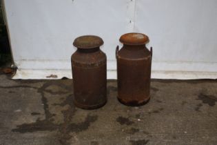 Two milk churns. Both with lids, one missing handles. H68cm.