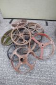 Ten assorted cast iron wheels.