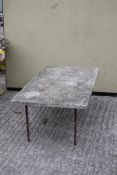 A small mid-century reconstituted stone garden table.