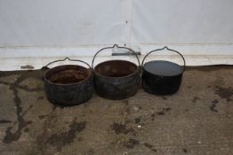 Three 19th century and later cast iron stew pots.