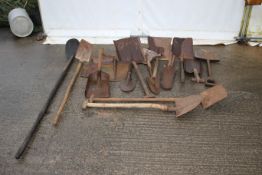 A collection of vintage shovels and shovel heads.