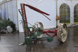 A Massey Harris finger bar mower. Model no. 34, in red with green trim and white cast iron wheels.