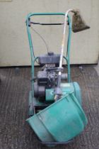 An Atco Qualcast petrol cylinder lawnmower plus a Honda strimmer.