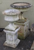 Two ornamental reconstituted stone garden urns on plinths. Max.