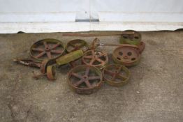 Twelve cast iron wheels. In various sizes, four with axles.