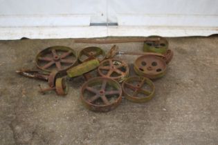 Twelve cast iron wheels. In various sizes, four with axles.