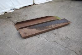 A pair of metal loading ramps.