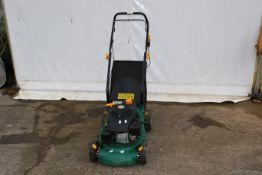 A petrol push along lawn mower. With a 118cc engine, complete with grass box.