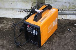 An Impax 140 welder. In orange complete with leads.
