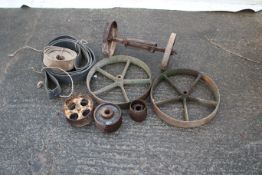 A collection of cast iron and stationary engine wheels.