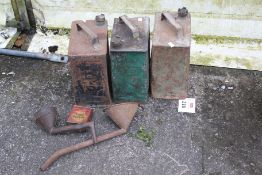 Three vintage fuel cans. Including a shell example plus funnels etc.