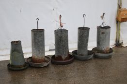Five galvanised metal chicken feeders. Appear sound in base, max H90cm.