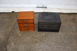 Two wooden tool chests containing drawing instruments.