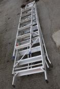 Three sets of aluminium step ladders.