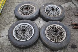 A set of four vintage MG sportscar wire wheels. With four tyres: Michelin X 165 15 Z X Radial.