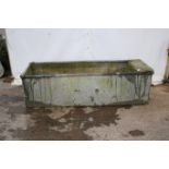 A galvanised riveted drinking trough. Complete with a plumbing box, H56cm x W186cm x D64cm.