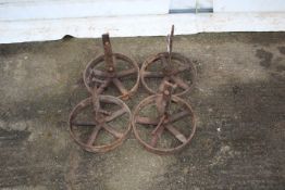 A set of four cast iron wheels. Complete with axles, diameter 30cm.