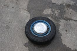 A spare trailer wheel. T-400, 145/80 R 13 75 T Radial Tubeless tyre.