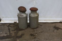 Two galvanised milk churns.