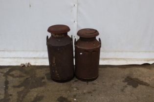 Two milk churns. Both with handles and lids, H75cm.