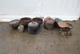 A collection of cast iron bygones. Including stew pots, a set of scales with weights etc.