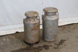 Two galvanised metal milk churns with lids.