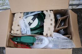 A hedge trimmer, grass trimmer and lawn mower set. In original box, electricity powered.