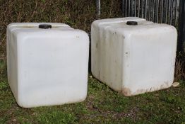 Two Schutz heavy duty white plastic IBC tanks.