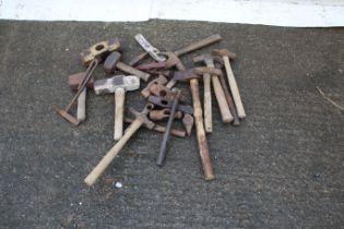 A large collection of hammers and hammer heads.