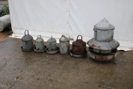 Five galvanised metal chicken feeders plus one lid. Various sizes in mixed condition, max H53cm.