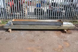 A galvanised metal feeder trough and a quanitity of corrigated motorway crash barriers