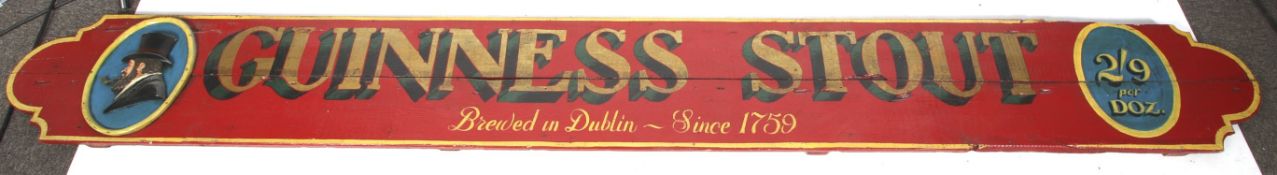 A vintage painted wood Guinness advertising sign.