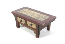 A 20th century Chinese style painted hardwood coffee table.