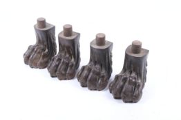 A set of four carved walnut lion's paw feet.