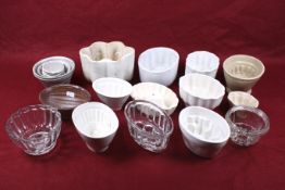 A collection of assorted jelly and other food moulds. Including eleven ceramic and three glass, etc.