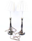 A pair of contemporary ebonised and gilt table lamps with shades.