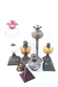 A group of assorted vintage oil lamps and spare parts.