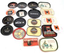 A collection of Guinness drinks trays. Of various forms, colours, patterns and sizes.