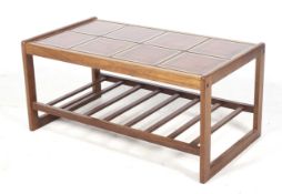 A mid-century Englender tile top teak coffee table. With eight ceramic tiles over a slatted shelf.