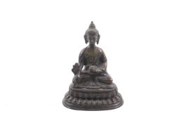 A Tibetan bronze figure of Buddha Shakyamuni.