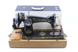 A mid-20th century Japanese Deluxe Kapitan hand crank sewing machine.