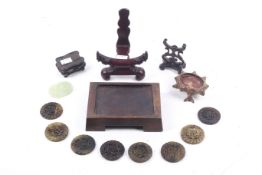 Five Chinese carved and pierced stands and nine hardstone plaques.