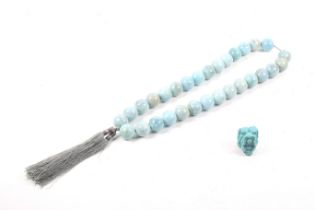 A string of blue stone 'monk's beads' and a netsuke.