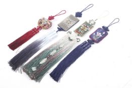 Four Korean norigae tassels. The embroidered pendants suspending red, green and blue tassels.