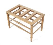 A vintage pine luggage rack. Raised on turned supports united by stretchers, H44cm x W69.5cm x D41.