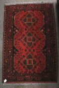 A 20th century Bokhara style wool prayer rug (red and black).