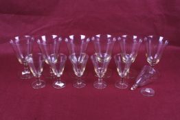Two sets of six Swedish glass drinking glasses. With orange tinted bases and stems, Max. H13.