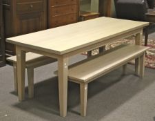 A contemporary limed oak long rectangular dining table and a pair of matching benches.