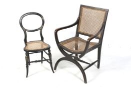 Two ebonised wood framed chairs with bergere cane seats.