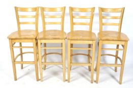 A set of four beech bar chairs.